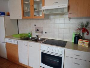 a kitchen with a sink and a stove at Apartments with a parking space Icici, Opatija - 7860 in Ičići
