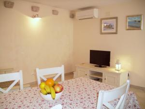 a room with a table with a bowl of fruit on it at Apartments with a parking space Komiza, Vis - 9247 in Komiža