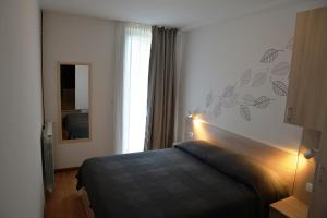 a hotel room with a bed and a mirror at Apartments with parking space Cres - 7876 in Cres