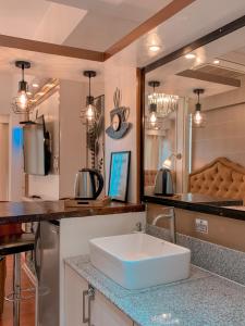 a kitchen with a sink and a counter top at GoldenSuites at CoolSuites WindResidences Tagaytay in Tagaytay