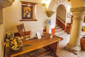 a living room filled with furniture and a table at Parador San Agustin in Oaxaca City