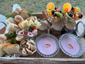 a tray of food with different types of bread and dips at Chalé Village Jângal in Machado