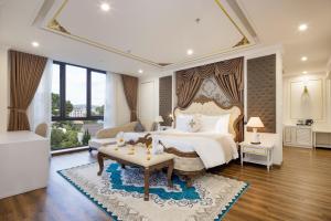 a bedroom with a large bed and a large window at Da Lat Prince Hotel in Da Lat