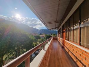 a balcony of a building with a view of the mountains at Pampa Bella Lodge in La Merced