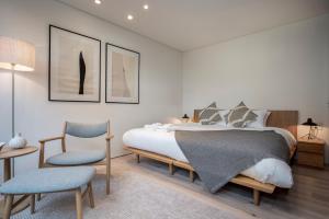 a bedroom with a bed and a table and chairs at Ryoun by H2 Life in Niseko