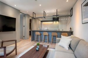 a living room with a couch and a kitchen at Ryoun by H2 Life in Kutchan