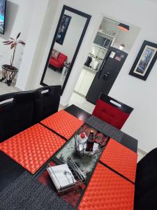 a dining room with red tables and a red chair at En el centro y hermosa vista! Con cochera in Trujillo