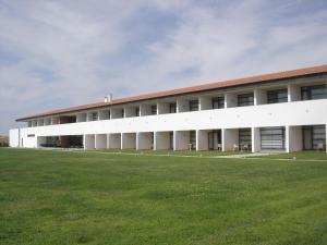a large building with a grass field in front of it at Hotel Rural Santo Antonio in Arronches