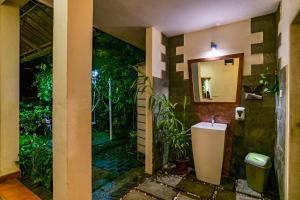 a bathroom with a sink and a mirror at Mistletoe Munnar Homestay & Cafe in Munnar +138 photos