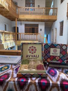 a table with a box of ayol on top of it at Bukhara Zaringiz PREMIUM in Bukhara