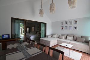 a living room with a couch and a table at My home resort - ขนอม นครศรีธรรมราช in Khanom