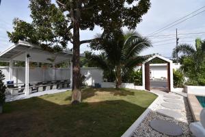 a backyard with a tree and a pavilion at My home resort - ขนอม นครศรีธรรมราช in Khanom