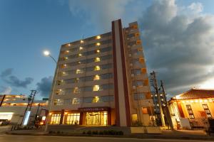 a tall building with lights in front of a building at Hotel Peace Island Ishigaki in Yashima in Ishigaki Island