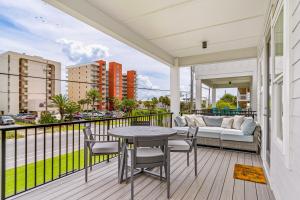 a balcony with a table and chairs and a couch at Lost Dunes #B in Gulf Shores