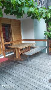 a picnic table and a bench on a deck at Enzian 176 Al , Wohnung C3 in Tiefencastel