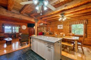 a kitchen and dining room in a log cabin at Mountain Memories in Sylva