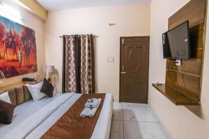 A bed or beds in a room at Blizz Hotels- Trishul Express