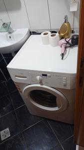 a washing machine in a bathroom with a sink at Sleep and drive 2 in Sarajevo