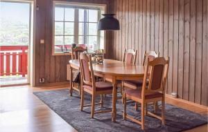 a dining room with a wooden table and chairs at Stunning Apartment In Vgslid With Wifi in Vågsli