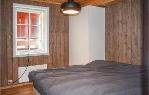 a bedroom with a bed and a window at Stunning Apartment In Vgslid With Wifi in Vågsli