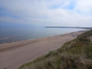 a group of people on a beach near the water at Holiday Home in Forfar +1 photo