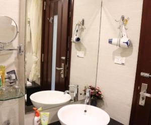 a bathroom with two sinks and a mirror at A25 Hotel - 88 Nguyễn Khuyến in Hanoi