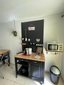 a kitchen with a table and a microwave at Casa Azzura in Bastia