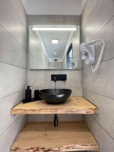 a bathroom with a bowl sink and a mirror at Casa Azzura in Bastia