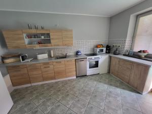 a kitchen with wooden cabinets and a white stove top oven at Land,Wald und Wiese in Jürgenstorf
