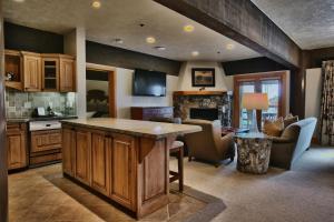 a kitchen with a large island and a living room at Luxury Three Bedroom Suite with Mountain Views and Hot Tub apartment hotel in Park City