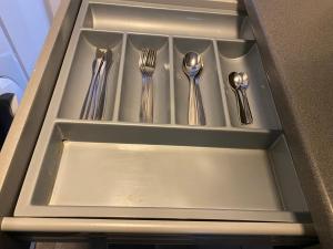a drawer with forks and spoons andsilverware on it at 105 Nelson str Ground Right in Largs