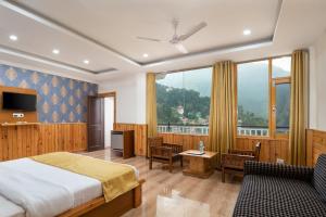 a bedroom with a bed and a large window at Mcleodgunj Mountain view in Dharamshala