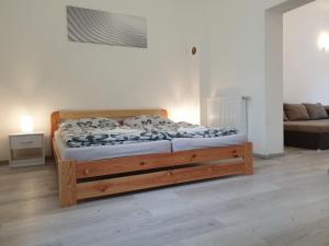 a bedroom with a wooden bed in a room at Brno apartment in Brno