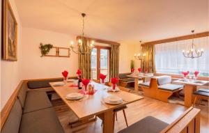 a living room with a table and some chairs at Beautiful Home In St, Gallenkirch With 6 Bedrooms, Sauna And Wifi in Aussersiggam