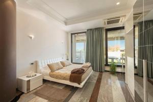 a bedroom with a bed and a large window at Hotel Residence Imperial in Misano Adriatico