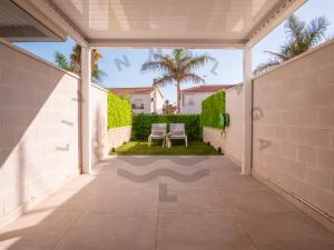an internal walkway leading to the backyard of a house at LivinMálaga Los Álamos Suites in Torremolinos