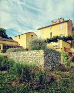 a stone retaining wall in front of a house at A Villa di Rutali in Rutali