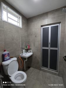 a bathroom with a toilet and a sink at Sehmi's Homestay, Pagoh, Muar in Pagoh