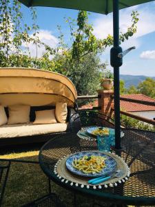 a table with a plate of food on a patio at Casa Teresina in Castellabate