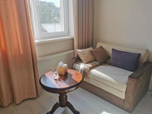 a small living room with a couch and a table at Lovely central 1BR apartment with a balcony in Chişinău