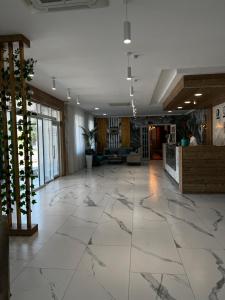 an office lobby with a large marble floor at KRich Hotel Aktobe in Aktobe