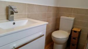 a bathroom with a white sink and a toilet at Purbeck Escape in Wareham +24 photos