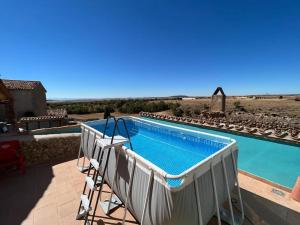 a swimming pool on a patio with a view of the desert at Hotel Boutique Malanquilla Inedita in Malanquilla