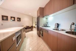 a kitchen with a sink and a counter top at Peppers Balé Luxury Beach Accommodation Kingscliff - privately let in Kingscliff