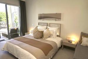 a bedroom with a large bed and a balcony at Peppers Balé Luxury Beach Accommodation Kingscliff - privately let in Kingscliff +6 photos