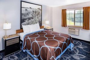 a hotel room with a bed and a window at Super 8 by Wyndham Johnstown/Gloversville in Johnstown