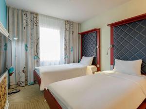 Postel nebo postele na pokoji v ubytování ibis Styles Hotel Berlin Mitte
