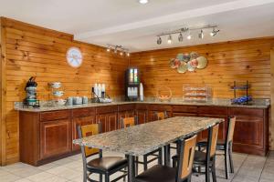 a kitchen with wooden walls and a table with chairs at Howard Johnson by Wyndham Pigeon Forge in Pigeon Forge
