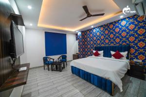Manī MājraHotel Red Apple Near Railway Station Chandigarh的一间带床和平板电视的卧室