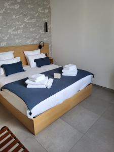 a bedroom with a large bed with towels on it at Hôtel L'Albatros in Saint-Trojan-les-Bains